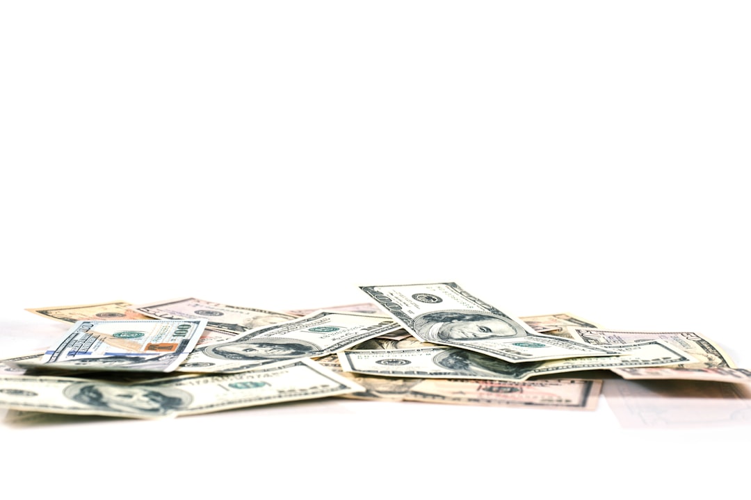 a pile of money sitting on top of a white table