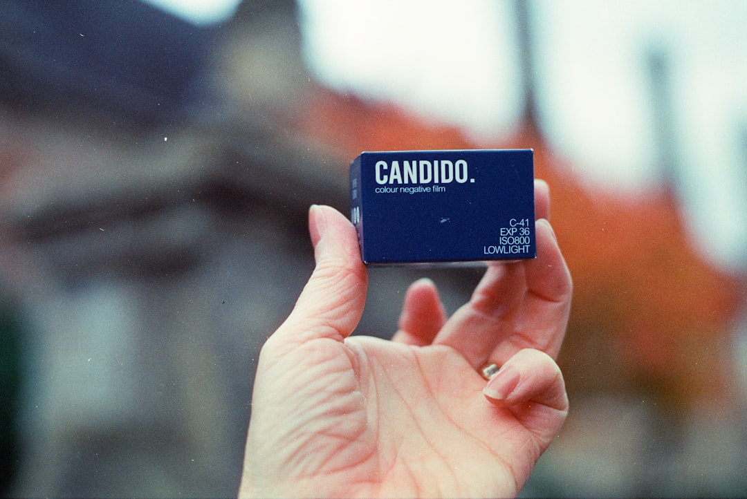 Hand holds small blue box with text